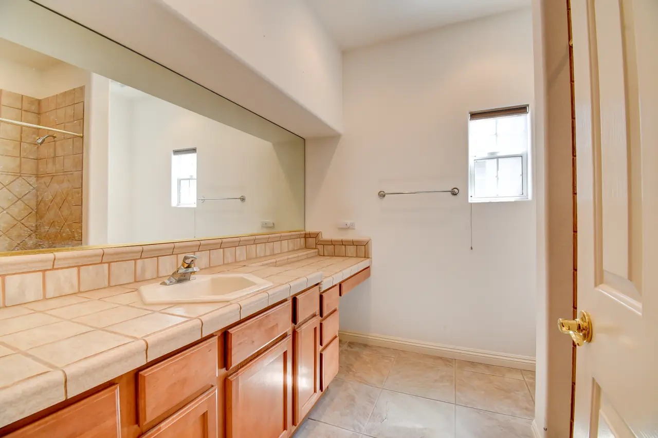 Bathroom with long tile vanity and mirror