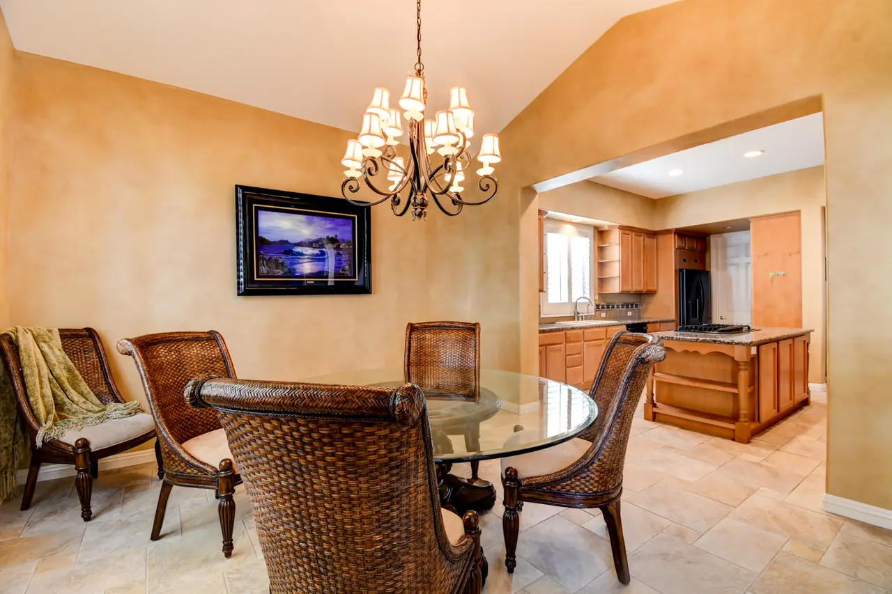Dining room with chandelier opening toward the kitchen