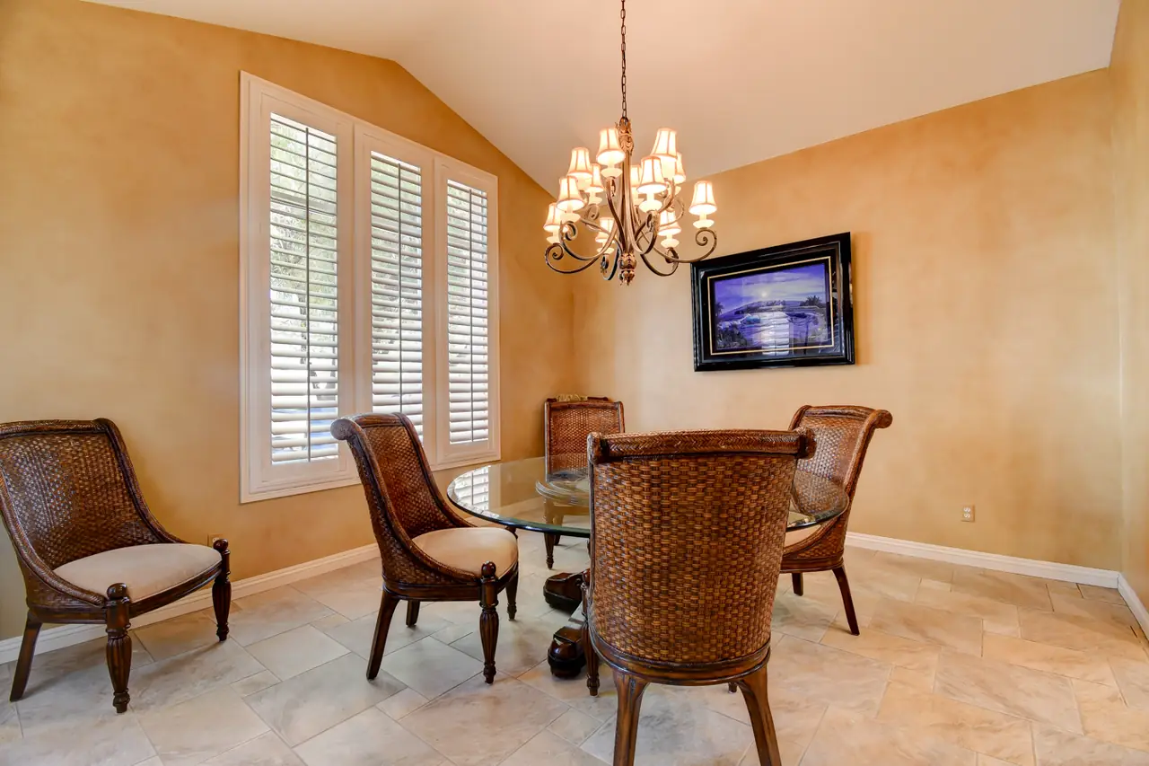 Formal dining room with chandelier, shutters and tile floor
