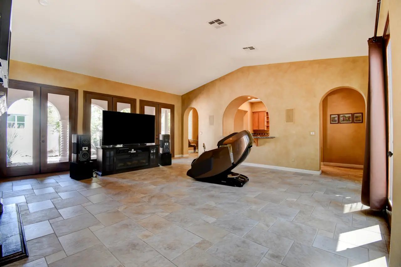 Great room with vaulted ceiling, fireplace and French doors to the patio