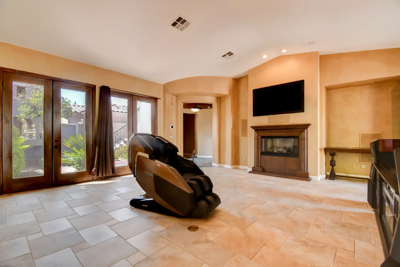 Great room with a row of French doors and a gas fireplace