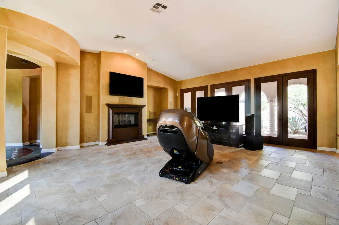 Great room fireplace wall with media area and arched niches