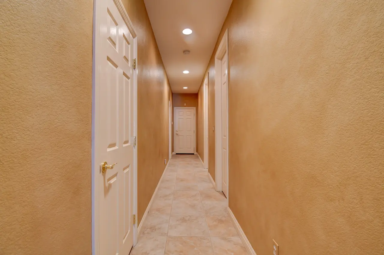 Hallway with arched niche leading to the bedrooms