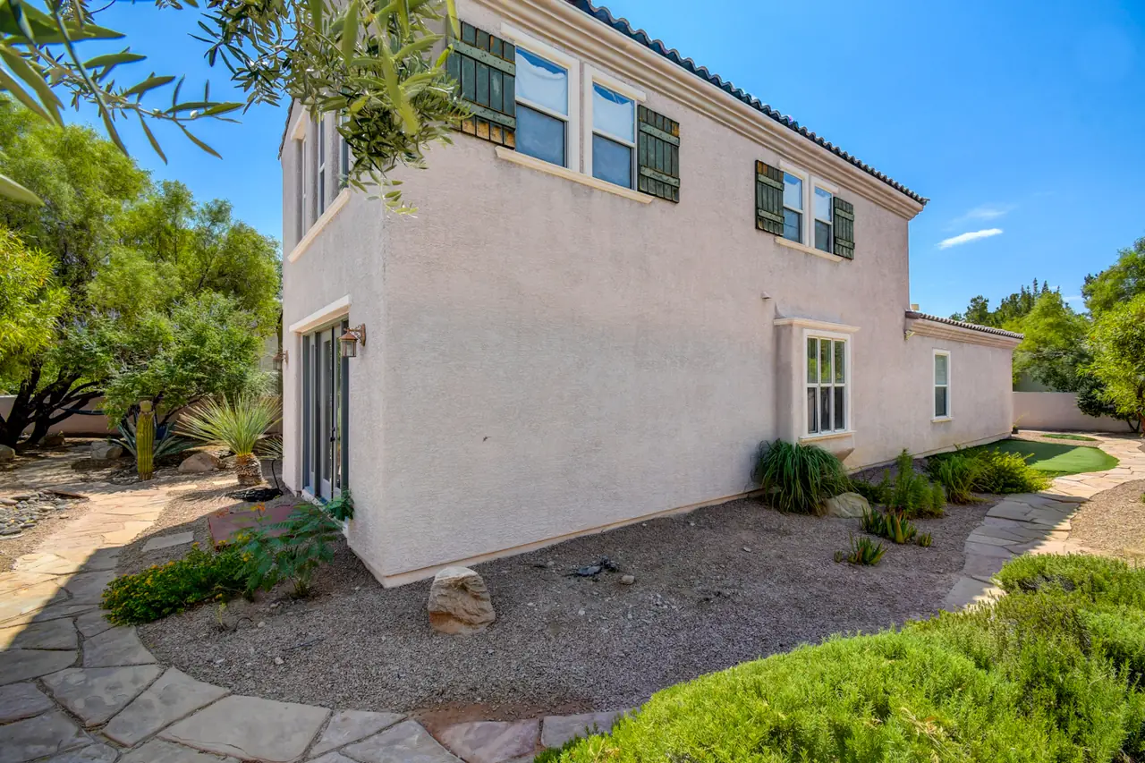 Side yard with desert landscaping along the two-story wing