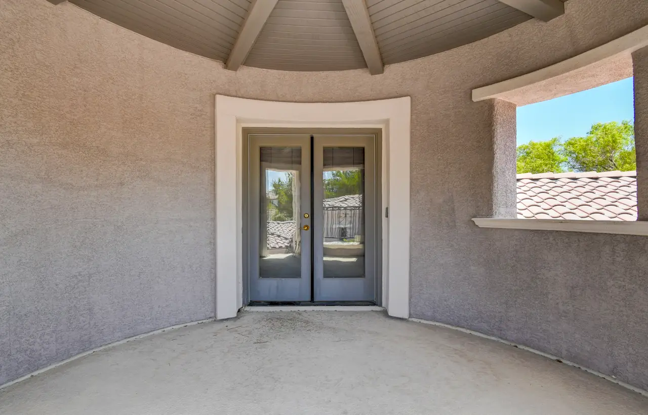 Octagonal tower room with French doors and beamed ceiling