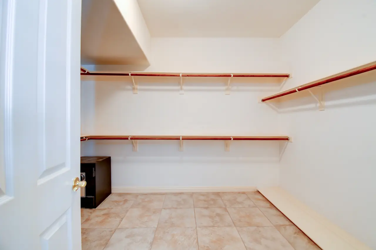 Walk-in closet with hanging rods and shelving